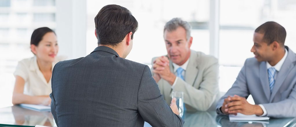 Businessman leads business meeting with other managers in board room 2