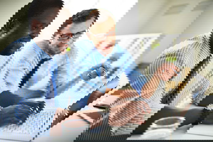 Two business-people using a laptop in an office