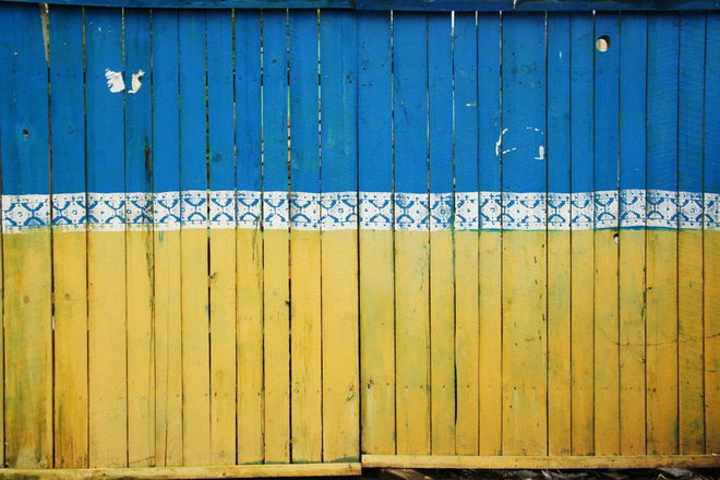 Wooden door with light blue and yellow colors