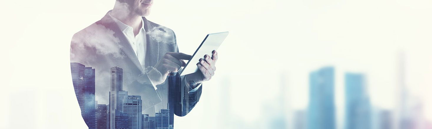 An unrecognizable man uses a iPad table