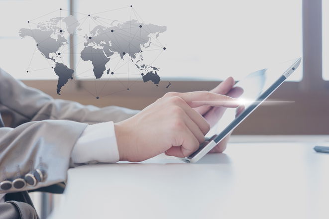 Businessman finger touching touch-pad with with an abstract connected world map design background